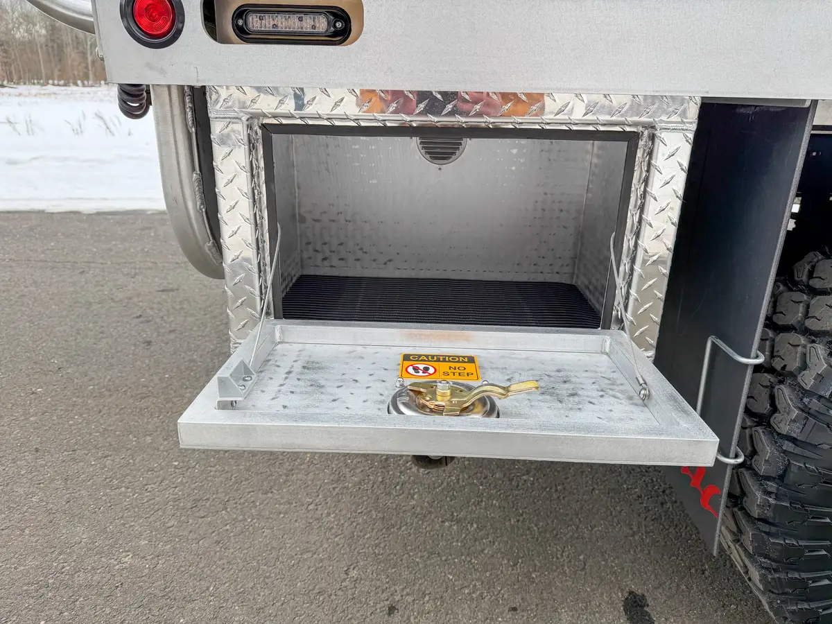 Open lower storage cubby near rear with black anti-slip mat.